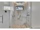 Luxurious glass shower with mosaic tile floor and a modern shower system at 6526 Simone Shores Cir, Apollo Beach, FL 33572