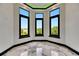 Bay window room with black trim and sleek flooring offers plentiful views and light at 6526 Simone Shores Cir, Apollo Beach, FL 33572