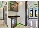 Modern wet bar with wine fridge and sleek black countertop adjacent to dining area at 6526 Simone Shores Cir, Apollo Beach, FL 33572