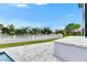 A well-maintained yard with a white fence and tropical plants surround the home at 6526 Simone Shores Cir, Apollo Beach, FL 33572