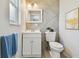 Modern bathroom with a sleek vanity, decorative mirror, and tiled accent wall, combining style and functionality at 6604 2Nd Ne Ave, Bradenton, FL 34208
