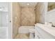 Bathroom featuring a shower-tub combo with tiled walls, complemented by a sleek white vanity at 6604 2Nd Ne Ave, Bradenton, FL 34208