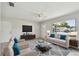 Bright living room with neutral tones, tile floors, and plenty of natural light from the sliding glass door at 6604 2Nd Ne Ave, Bradenton, FL 34208
