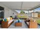 Relaxing screened patio with wicker furniture and plush cushions, perfect for outdoor lounging and entertaining at 6604 2Nd Ne Ave, Bradenton, FL 34208