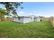 Spacious backyard with lush green grass and new wooden fence surrounding the home, ensuring privacy at 6804 Tierra Verde St, Port Richey, FL 34668