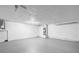 Spacious unfinished basement with sealed flooring, white walls, and utility access, ready for customization at 6804 Tierra Verde St, Port Richey, FL 34668