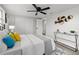 Bright bedroom featuring a ceiling fan, large closet and a decorative wall piece above a console table at 6804 Tierra Verde St, Port Richey, FL 34668