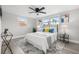 Bright bedroom with hardwood floors, a modern ceiling fan and contemporary artwork above the bed and side tables at 6804 Tierra Verde St, Port Richey, FL 34668