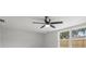 Bright bedroom featuring a ceiling fan and a view of the fenced backyard at 6804 Tierra Verde St, Port Richey, FL 34668