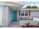 Inviting front porch with colorful chairs, stylish accents, and a beautifully landscaped garden bed at 6804 Tierra Verde St, Port Richey, FL 34668