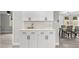 Modern kitchen bar area with white cabinets, sleek countertops, and stylish hardware at 6804 Tierra Verde St, Port Richey, FL 34668