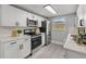 Modern kitchen with stainless steel appliances, white cabinets, and a bright, clean design at 6804 Tierra Verde St, Port Richey, FL 34668