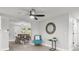 Modern living room with a ceiling fan, view into the dining area, and sleek decor at 6804 Tierra Verde St, Port Richey, FL 34668