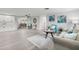 Bright living room featuring neutral tones, modern furnishings, and an open layout with a dining area at 6804 Tierra Verde St, Port Richey, FL 34668
