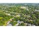 A stunning aerial view of a neighborhood surrounded by mature trees and a large green field at 6918 Potomac Cir, Riverview, FL 33578