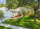 Aerial view of a single-story home with a well-maintained lawn and surrounding mature trees at 6918 Potomac Cir, Riverview, FL 33578