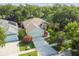 High aerial shot of a home with a screened-in pool enclosure and surrounded by mature trees at 6918 Potomac Cir, Riverview, FL 33578