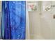 Bathroom with blue shower curtain, and a window in shower at 6918 Potomac Cir, Riverview, FL 33578