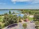 View of the lakeside clubhouse and pool area featuring palm trees and a picturesque lake with a fountain at 6918 Potomac Cir, Riverview, FL 33578