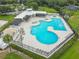 Aerial view of a community pool with a sand volleyball court and many amenities in a well-maintained landscape at 6918 Potomac Cir, Riverview, FL 33578