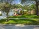 Charming single-story home with mature trees, a well-manicured lawn, and inviting curb appeal at 6918 Potomac Cir, Riverview, FL 33578