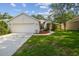 Inviting single-story home featuring a two-car garage, landscaped front yard, and charming curb appeal at 6918 Potomac Cir, Riverview, FL 33578