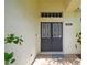 Close-up of the home's double front doors and a welcoming porch with ceramic tile flooring at 6918 Potomac Cir, Riverview, FL 33578