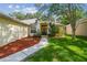 Charming home showcasing a well-manicured lawn, mature trees, and a welcoming walkway to the front door at 6918 Potomac Cir, Riverview, FL 33578