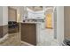 Bright kitchen features white cabinets, granite countertops, and tile flooring at 6918 Potomac Cir, Riverview, FL 33578