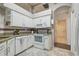 Kitchen featuring white appliances and a doorway leading to another room at 6918 Potomac Cir, Riverview, FL 33578