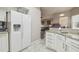 White refrigerator in a kitchen with granite countertops and tiled floors at 6918 Potomac Cir, Riverview, FL 33578