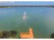 Picturesque lake view featuring a fountain, wooden pier, and lush shoreline vegetation at 6918 Potomac Cir, Riverview, FL 33578