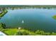 Panoramic view of a lake with a fountain, surrounded by lush greenery and residential homes at 6918 Potomac Cir, Riverview, FL 33578