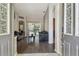 Open-concept living room features hard wood floors and sliding glass doors leading to the outdoor pool at 6918 Potomac Cir, Riverview, FL 33578
