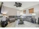 Living room features a large gray sectional couch and decorative ceiling fan at 6918 Potomac Cir, Riverview, FL 33578