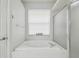 Bright bathroom features a tub, shower and window at 6918 Potomac Cir, Riverview, FL 33578