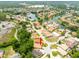 Aerial view of a neighborhood, showcasing its location with lakes and trees around the property at 6928 Cozumel Ct, Land O Lakes, FL 34637