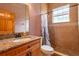 Bathroom with a granite countertop vanity, toilet, and tiled walk-in shower at 6928 Cozumel Ct, Land O Lakes, FL 34637