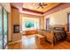 The main bedroom with decorative ceiling, a large fireplace and adjacent to a patio via a sliding glass door at 6928 Cozumel Ct, Land O Lakes, FL 34637
