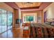 A spacious bedroom featuring wood floors, a fireplace and a large sliding glass door with a view of nature at 6928 Cozumel Ct, Land O Lakes, FL 34637