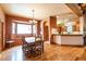 Dining room with wood floors, a large window, and access to the kitchen at 6928 Cozumel Ct, Land O Lakes, FL 34637
