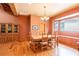 Dining room featuring wood floors, a large window, and a wooden dining table at 6928 Cozumel Ct, Land O Lakes, FL 34637