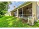 View of the screened-in patio, showing the outdoor space and lush backyard at 6928 Cozumel Ct, Land O Lakes, FL 34637