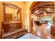 Open foyer leading to a living room with wood floors and exposed beam ceilings at 6928 Cozumel Ct, Land O Lakes, FL 34637