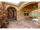 Inviting covered front porch with stone accents, brick pavers, and a charming swing at 6928 Cozumel Ct, Land O Lakes, FL 34637