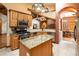 A kitchen view with stainless steel appliances, a center island, and an open view into the adjacent dining room at 6928 Cozumel Ct, Land O Lakes, FL 34637