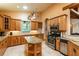 Gourmet kitchen with granite countertops, stainless steel appliances, and custom cabinetry at 6928 Cozumel Ct, Land O Lakes, FL 34637