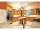 Open kitchen with granite countertops, an island, and custom cabinets at 6928 Cozumel Ct, Land O Lakes, FL 34637