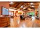 Open-concept living room featuring wood floors, a fireplace, and exposed beam ceilings at 6928 Cozumel Ct, Land O Lakes, FL 34637