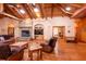 Comfortable living room featuring a stone fireplace, wood floors, ceiling fans, and lots of natural light at 6928 Cozumel Ct, Land O Lakes, FL 34637